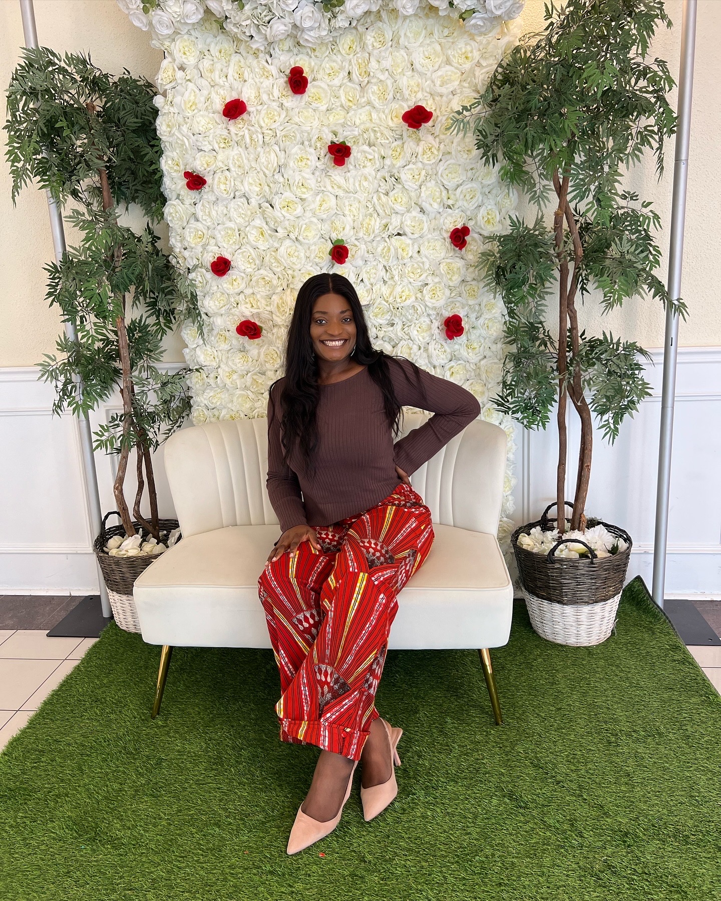 Yvonne Ben by a floral wall